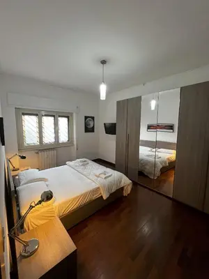 a bedroom with a large bed and a mirror at Moonlight Vatican by ACS HOLIDAYS in Rome