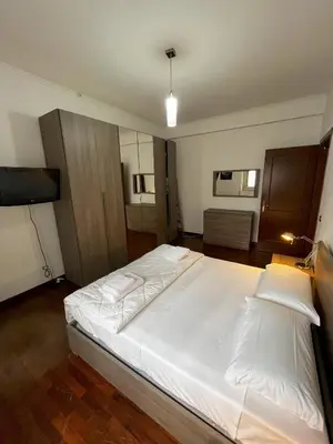 a bedroom with a large white bed in a room at Moonlight Vatican by ACS HOLIDAYS in Rome