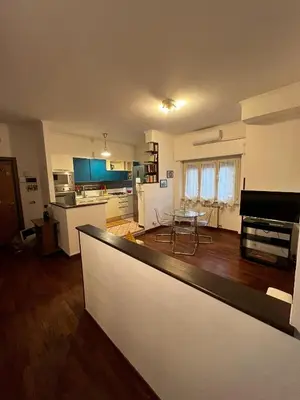 a large living room with a kitchen and a table at Moonlight Vatican by ACS HOLIDAYS in Rome