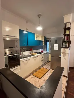 a kitchen with stainless steel appliances and blue cabinets at Moonlight Vatican by ACS HOLIDAYS in Rome