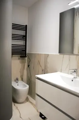 a bathroom with a sink and a tub and a toilet at Domus Dea Roma by Trinità in Rome