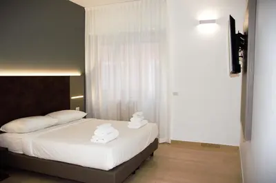 a bedroom with a bed with two towels on it at Domus Dea Roma by Trinità in Rome