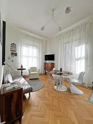 a living room with a table and chairs at Roma Parioli - Suite Mediterranea in Rome