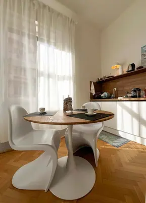 a kitchen with a table and two chairs and a table at Roma Parioli - Suite Mediterranea in Rome
