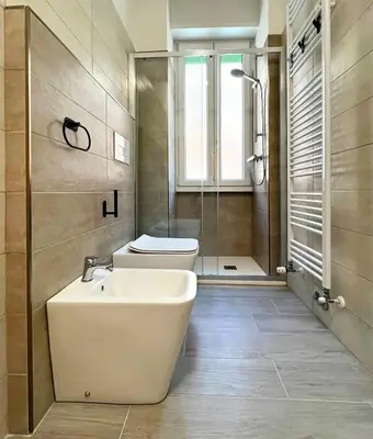 a bathroom with a toilet and a sink and a shower at Appartamento Amy House in Rome