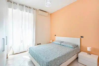 a bedroom with a bed and a large window at Appartamento Amy House in Rome