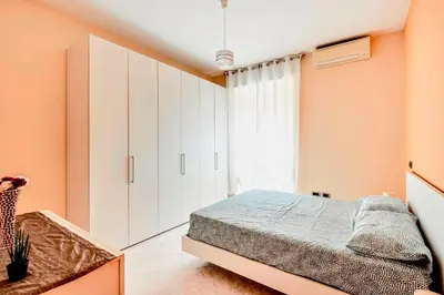 a bedroom with orange walls and a large bed at Appartamento Amy House in Rome