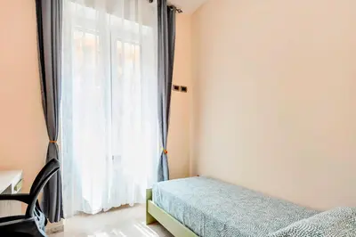 a bedroom with two beds and a window at Appartamento Amy House in Rome