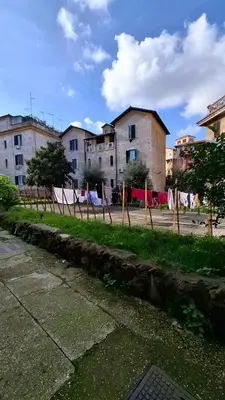 a street with a fence and buildings in the background at Casetta Garbatella in Rome
