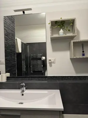 a bathroom with a sink and a mirror at Splendido Attico con Terrazza a Trastevere in Rome