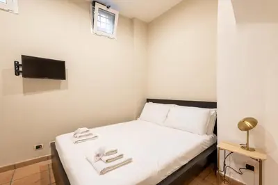 a small bedroom with a bed with towels on it at Loft nel Cuore della Capitale in Rome