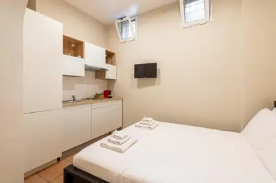 a white room with a bed and a sink at Loft nel Cuore della Capitale in Rome