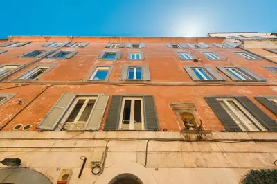 a tall brick building with many windows on it at Loft nel Cuore della Capitale in Rome