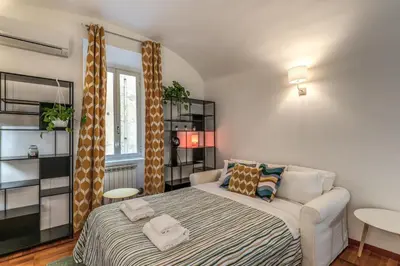 a small bedroom with a bed and a window at Fresh House Sapienza in Rome