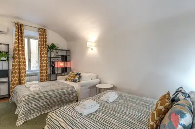 a living room with two beds and a couch at Fresh House Sapienza in Rome
