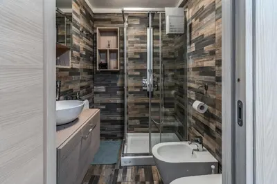 a bathroom with a shower and a toilet and a sink at Fresh House Sapienza in Rome