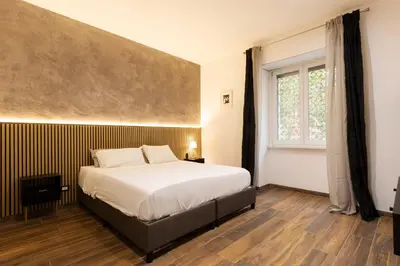 a bedroom with a large bed and a window at Alma Musa Piazza Bologna Apartment in Rome
