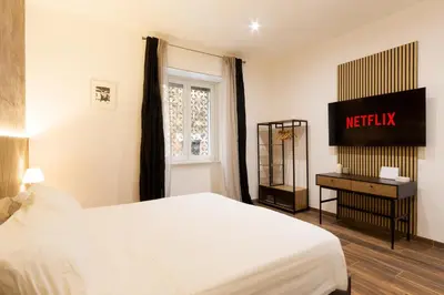 a hotel room with a bed and a sign on the wall at Alma Musa Piazza Bologna Apartment in Rome