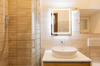 a bathroom with a sink and a mirror at Alma Musa Piazza Bologna Apartment in Rome