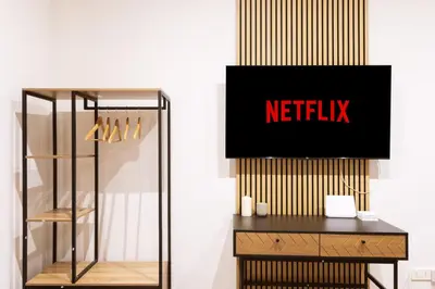 a glass cabinet with a netflix sign on a wall at Alma Musa Piazza Bologna Apartment in Rome
