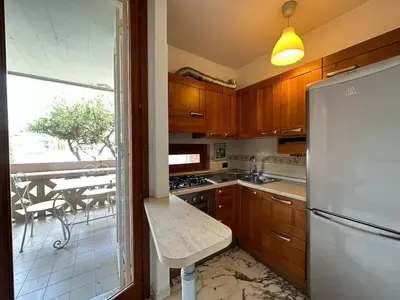 a kitchen with a stainless steel refrigerator and a table at The Vatican Studio in Rome