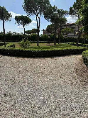 a park with a bench and trees and grass at The Vatican Studio in Rome