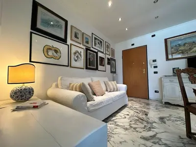 a living room with a white couch and a table at The Vatican Studio in Rome