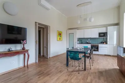 a kitchen and dining room with a table and chairs at iFlat Vatican New Bright & Comfy 3 Bedroom apt in Rome