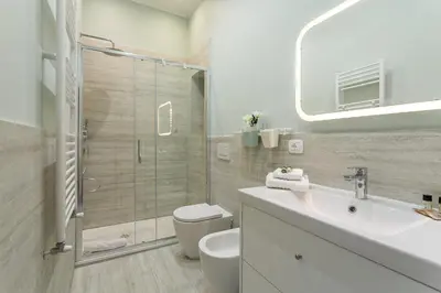 a bathroom with a shower and a toilet and a sink at iFlat Vatican New Bright & Comfy 3 Bedroom apt in Rome