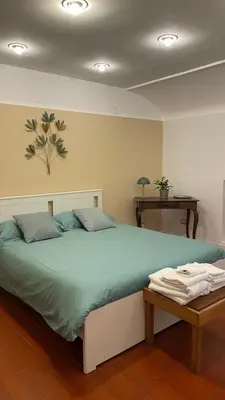 a bedroom with a large bed and a table at Appia apartment in Rome