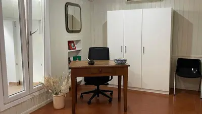 a room with a desk and a mirror and a cabinet at Appia apartment in Rome