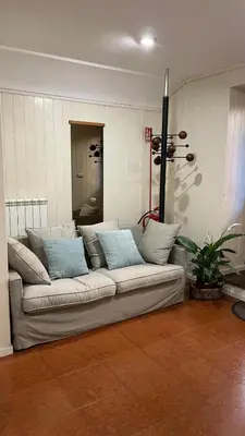 a couch in a living room with blue and white pillows at Appia apartment in Rome