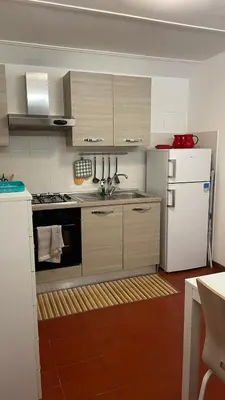 a kitchen with a stove and a refrigerator at Appia apartment in Rome