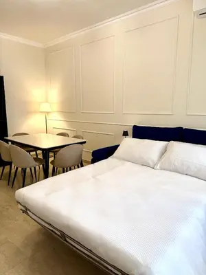 a bedroom with a bed and a table with chairs at SarHome in Rome