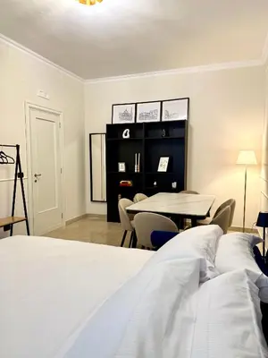 a bedroom with a bed and a table and chairs at SarHome in Rome