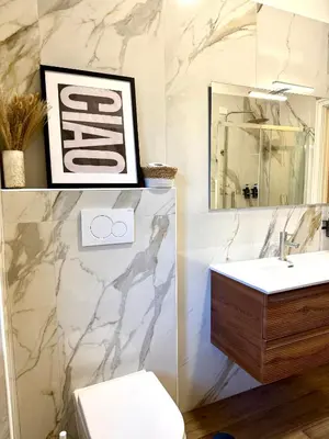 a bathroom with a sink and a toilet and a mirror at SarHome in Rome