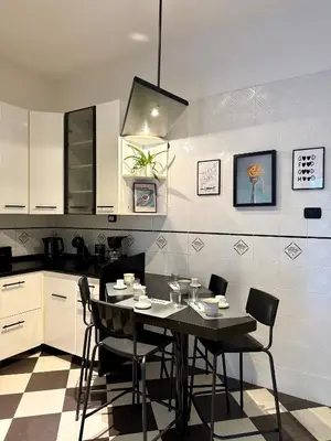 a kitchen with a table and chairs in a kitchen at SarHome in Rome