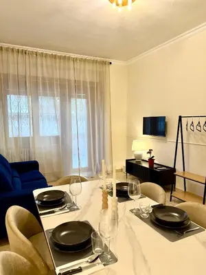 a dining room with a table with glasses and chairs at SarHome in Rome