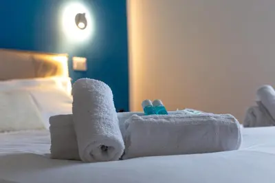 a towel animal made out of towels on a bed at iFlat Rome Dream, New Cozy & Chic Apartment in Rome