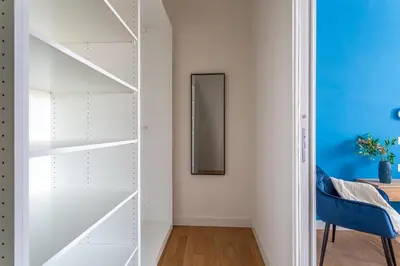 a room with white shelves and a mirror at iFlat Rome Dream, New Cozy & Chic Apartment in Rome