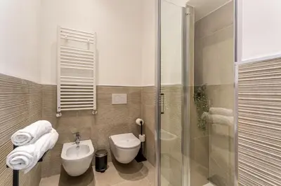 a bathroom with a toilet and a sink and a shower at iFlat Rome Dream, New Cozy & Chic Apartment in Rome
