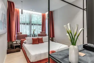 a living room with a couch and a table at Parioli Cube Hotel in Rome