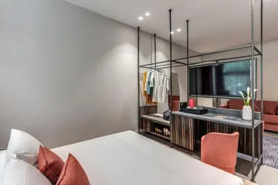 a bedroom with a large bed and a tv at Parioli Cube Hotel in Rome
