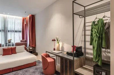 a hotel room with a bed and a desk at Parioli Cube Hotel in Rome