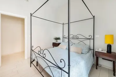 a bed with a metal canopy in a bedroom at Green apartment Rome in Rome