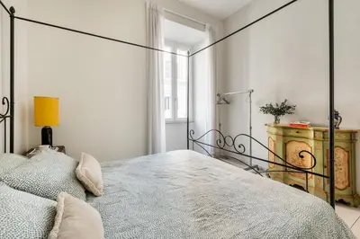 a bedroom with a large bed in a white room at Green apartment Rome in Rome