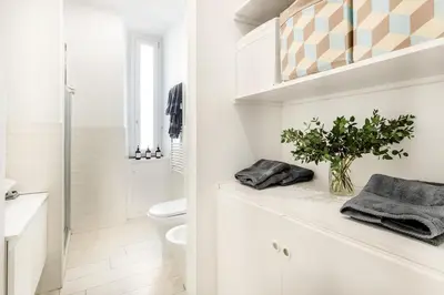 a white bathroom with a toilet and a shower at Green apartment Rome in Rome
