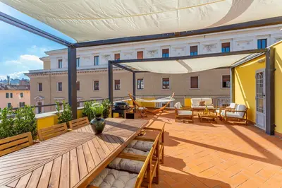 a patio with a wooden table on a balcony at Daplace - Cosima Apartment III in Rome