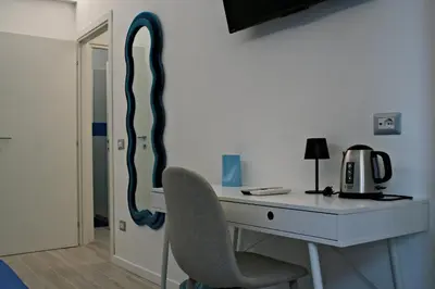 a room with a desk with a chair and a mirror at Terrazza Majorana in Rome