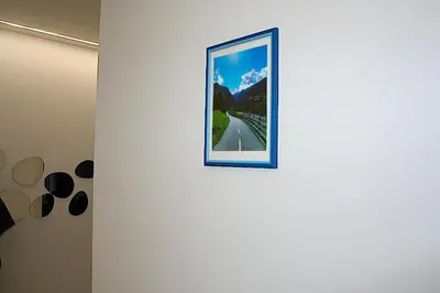 a picture on a white wall with a blue frame at Terrazza Majorana in Rome
